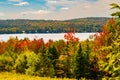 Vermont lake surrounded by fall foliage colors in autumn