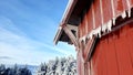 Vermont views Is icicles on frozen barn with blue sky vista in the distance