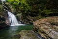 Vermont waterall flows into hidden rocky pool in the forest