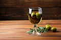 vermouth glass with olive garnish on wooden table