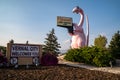 Sign for Vernal Utah, with its famous pink dinosaur statue, taken at dusk