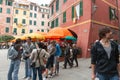 Crowded with tourists and umbrellas popular tourist destination Piazza Marconi in Cinque Terre Italy