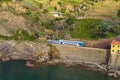 Scenic nature landscape in Cinque Terre. The passenger train enters the tunnel. Royalty Free Stock Photo