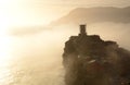 Tower of Castello Dorio in the mist at sunset. Vernazza. Cinque Terre National Park. Liguria. Italy