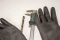 vernier caliper  drills and work gloves. Working in a workshop Royalty Free Stock Photo