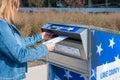 Vernon Hills, IL/USA - 10-10-2020: Woman using secure outdoor ballot drop box for early voting