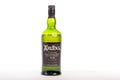 A bottle of peated Islay Single malt Schotch Whisky on a white background. Royalty Free Stock Photo