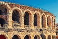 The Verona Arena limestone walls with arch windows in Piazza Bra square