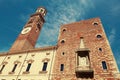 VERONA, ITALY - AUGUST 17, 2017: Plaza delle Erbe. Dei Lamberti Torre clock tower in Verona. Royalty Free Stock Photo