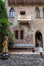 Verona, Italy - August 6, 2019: Tourists take photo with bronze statue of Guilietta, from romeo and juiliet Royalty Free Stock Photo