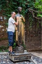 Verona, Italy - August 6, 2019: Tourists take photo with bronze statue of Guilietta, from romeo and juiliet Royalty Free Stock Photo