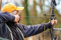 Close-up of a Male Archer Aiming with a Hunting Compound Bow