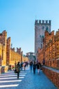 VERONA, ITALY, MARCH 19, 2016: People are crossing river adige via ponte scaligero bridge in the italian city verona Royalty Free Stock Photo