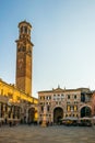 VERONA, ITALY, MARCH 19, 2016: people are strolling through piazza die signori dominated by torre die lamberti in the