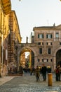 VERONA, ITALY, MARCH 19, 2016: people are strolling through piazza die signori dominated by torre die lamberti in the