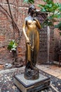 Verona, Italy Ã¢â¬â March 2019. Statue of Juliet in garden of Gothic-style 1300s house and museum, with a stone balcony, said to Royalty Free Stock Photo