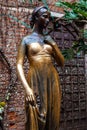 Verona, Italy Ã¢â¬â March 2019. Statue of Juliet in garden of Gothic-style 1300s house and museum, with a stone balcony, said to Royalty Free Stock Photo