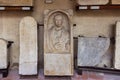 Fragments of decoratively decorated stone gravestones at an exhibition in the Museo Lapidario Maffeiano in Verona, Italy