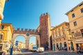 Portoni della Bra gate with merlons and clock, old Roman city