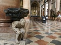 VERONA, VENETO, ITALY - February 15, 2019 Grumpy man stone statue supporting a fount with his back inside catholic church