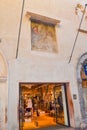 Entrance of fashion store in old building with biblical scene Verona Italy