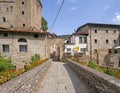 VERRUCOLA, LUNIGIANA, ITALY - AUGUST 12, 2019 - Bridge entrance to Verrucola, picturesque village with its castle Royalty Free Stock Photo