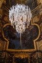 Chandelier and ceiling in the Hall of Mirrors of Palace of Versailles, France