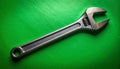 Versatile Adjustable Wrench on a Green Surface Royalty Free Stock Photo