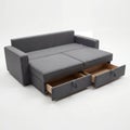 A versatile dark grey sofa bed featuring convenient pull-out storage drawers against a white background. Royalty Free Stock Photo