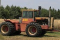 A 835 VERSATILE farm tractor in a farm field with sky