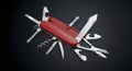 Versatile Red Swiss Army Knife: Utility, Functionality, and Precision Engineering on Black Royalty Free Stock Photo