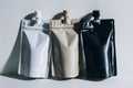 Versatile trio of colorful stand up pouches with matching caps for sleek packaging