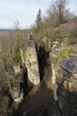 Verti shot of a pathway in the forest surrounded by cliffs Royalty Free Stock Photo