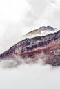 vertical abstract of colorful cliff sides in clouds and fog