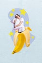 Vertical abstract image of positive funky mini girl inside banana fruit hold hug soft pillow isolated on creative stars
