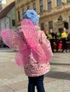 Vertical ack view of a little girl wearing pink butterfly wings Royalty Free Stock Photo