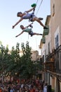 Acrobats during show on buildind facade vertical