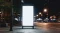 Vertical advertising billboard on sidewalk at night with copy space