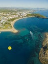 Vertical aerial drone view of Turkish town - Okurcalar - and its cityscape, and seashore area. Parachuting tourists Royalty Free Stock Photo