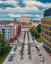 Vertical aerial of the Grand Theater behind a busy street in Lodz, Poland