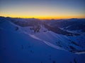 Vertical aerial panorama of snowy mountain ridge on winter sunrise. Stunning mountains range covered with snow at sunset Royalty Free Stock Photo