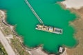 Vertical aerial photograph of a suction dredger in a wet mining area for sand and gravel, with connected pipeline to remove the Royalty Free Stock Photo