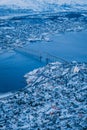 Vertical aerial shot of the beautiful city of Tromso covered in snow captured in Norway Royalty Free Stock Photo