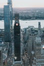 Vertical aerial shot of limitless skyscrapers on New-York sunrise background