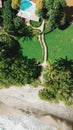 Vertical aerial top view of an exotic resort near the shore of Playa Negra, Costa Rice