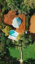 Vertical aerial top view of an exotic resort near the shore of Playa Negra, Costa Rice