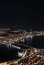 Vertical aerial of the Tromso Bridge with the night skyline of Tromso city, Norway Royalty Free Stock Photo