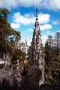 Vertical aerial view of Quinta da Regaleira castle in Sintra, Portugal on blue cloudy sky background