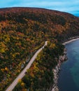 Vertical aerial view of a road through a colorful autumn forest on Cape Breton Island Royalty Free Stock Photo