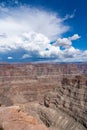 Vertical aerial view of sandstones in Grand Canyon National Park under blue cloudy sky in Arizona